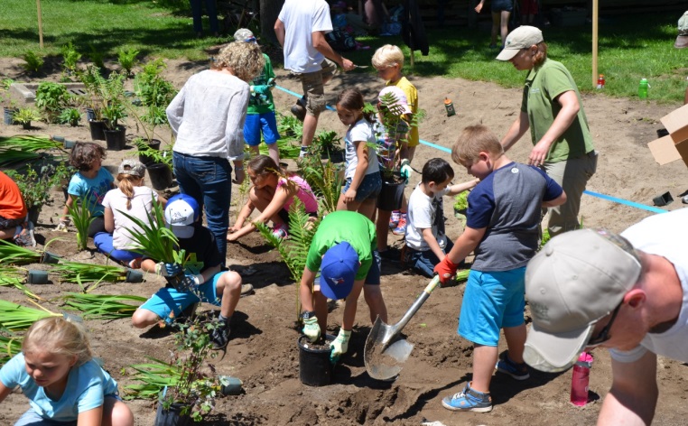 Volunteers taking part in community rain garden planting.